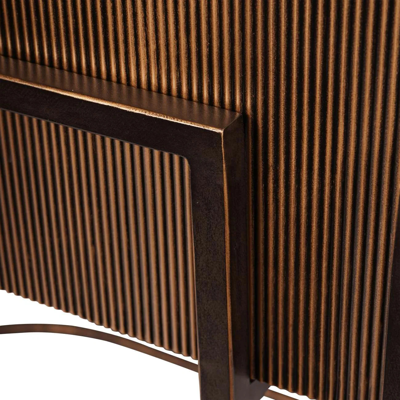 Ribbed gold console detail with dark metal frame.