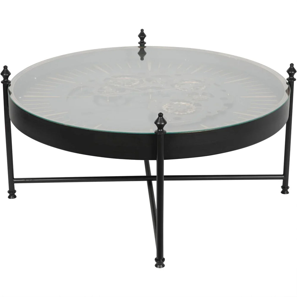 Black round coffee table with glass top and visible gold cogs.