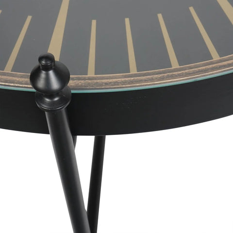 Black and gold table edge with sleek black legs and decorative knob detail.