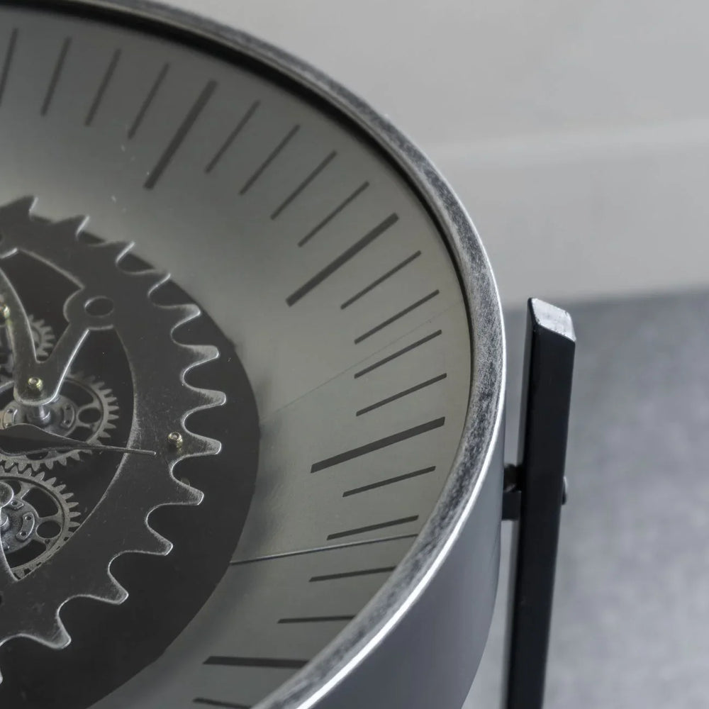 Black nickel table clock with visible moving cogs and sleek dial design.