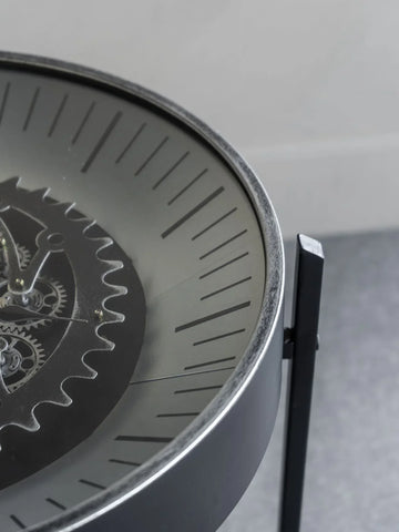 Black nickel table clock with visible moving cogs and sleek dial design.