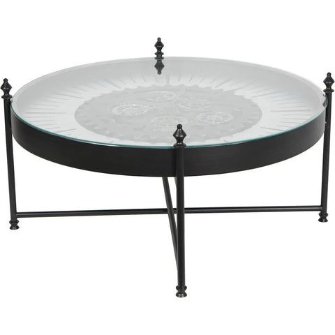 Round glass coffee table with visible cogs and black metal frame.