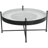 Round glass coffee table with visible cogs and black metal frame.