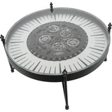 Round clock table with visible cogs and black metal legs.