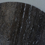 Dark travertine surface with rich, textured veining patterns.