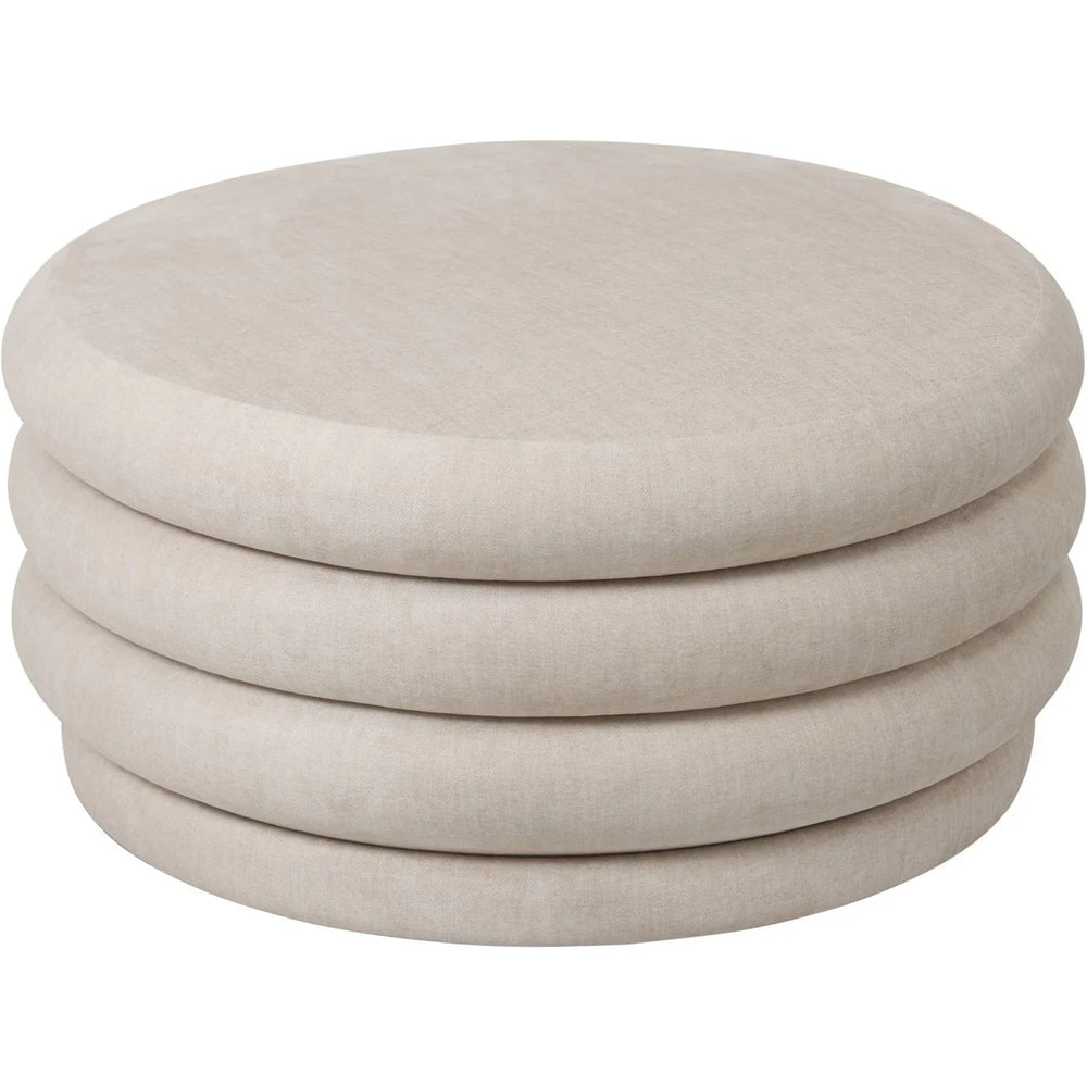Cream round ottoman with layered cushion design.