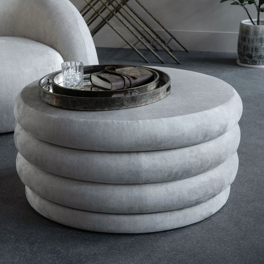 Cream ottoman with layered design in modern living room setting