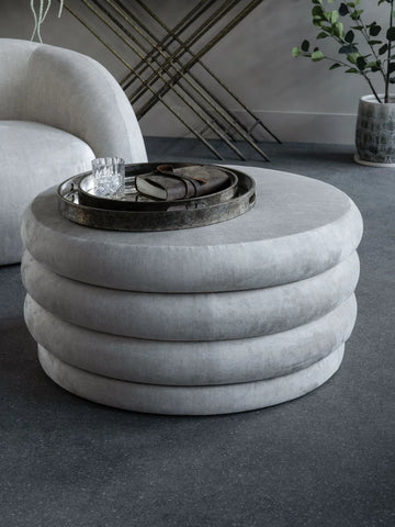 Cream ottoman with layered design in modern living room setting