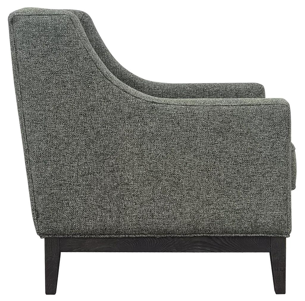 Forest green armchair side view with textured upholstery and dark wooden legs.