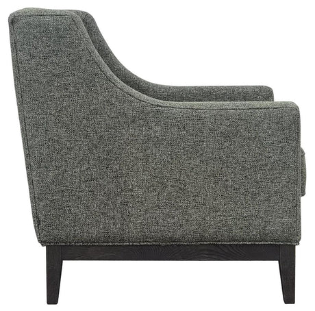 Forest green armchair side view with textured upholstery and dark wooden legs.