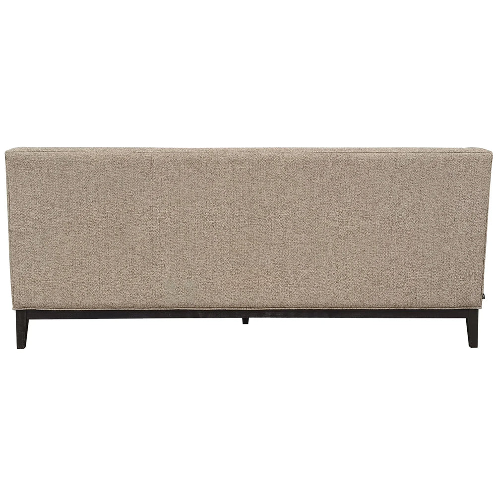 Back view of taupe sofa with textured fabric and dark wooden legs.