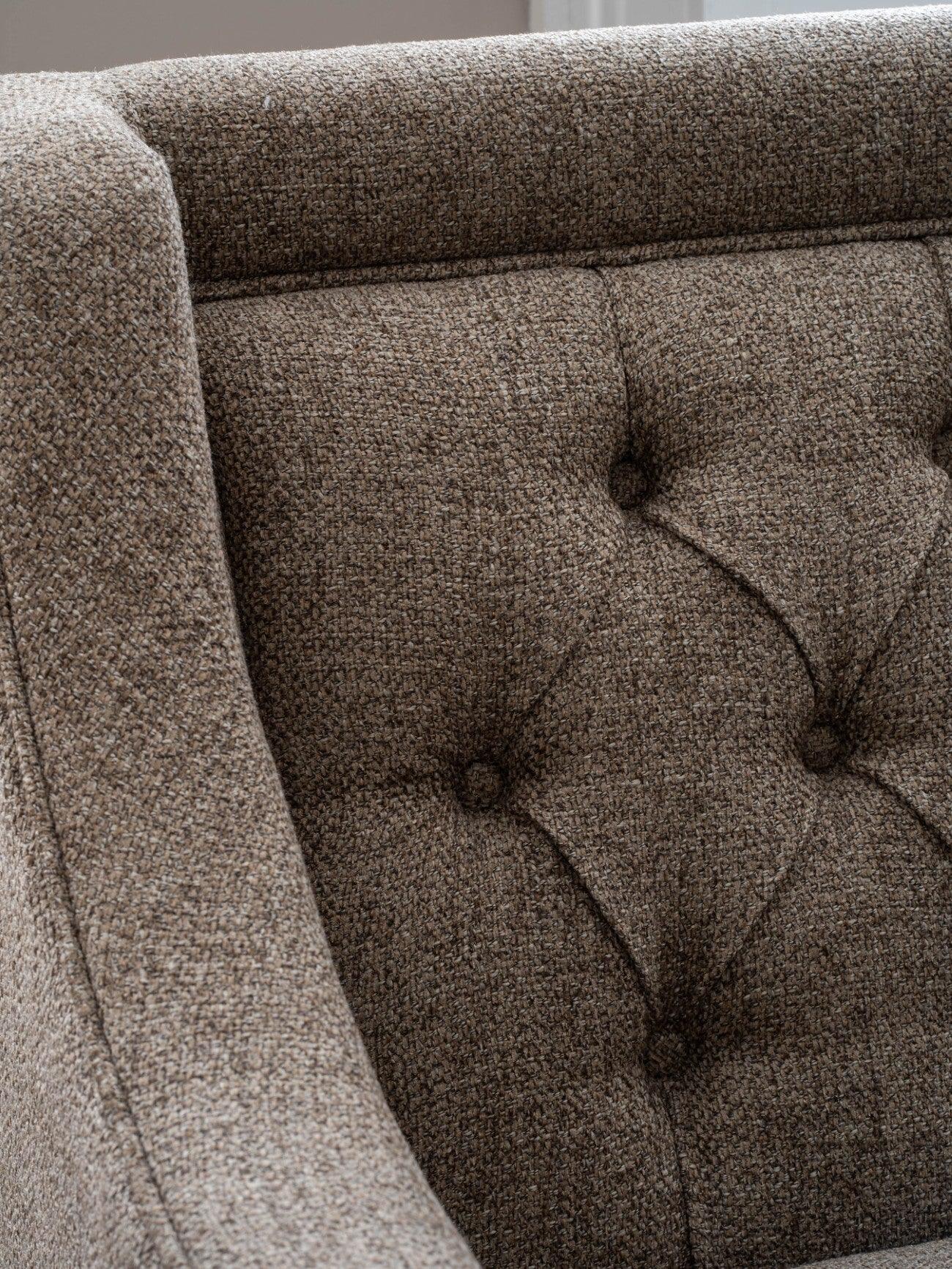 Dark taupe sofa with buttoned backrest and textured fabric detail.