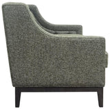 Forest green sofa side view with textured fabric and dark wooden legs.