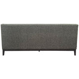 Back view of a forest green sofa with textured upholstery.