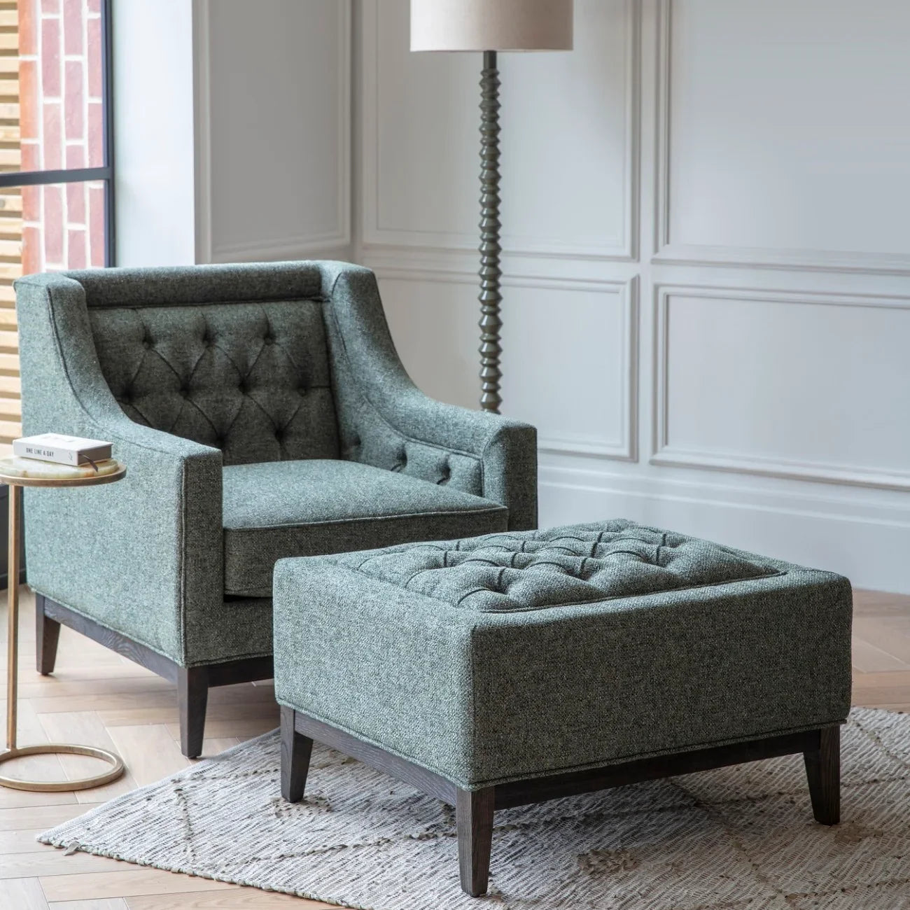 Forest green buttoned stool in elegant living room with matching armchair.