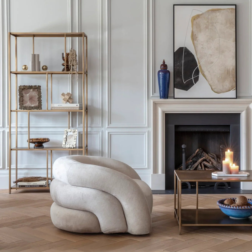 Brushed champagne shelving unit in elegant living room with modern decor.