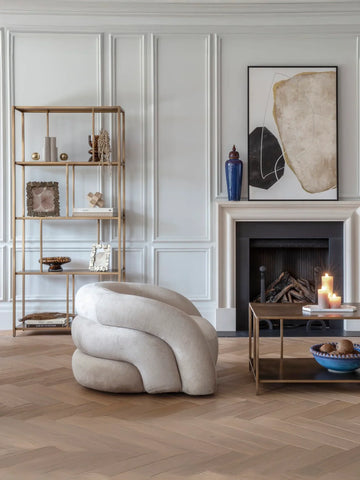 Brushed champagne shelving unit in elegant living room with modern decor.