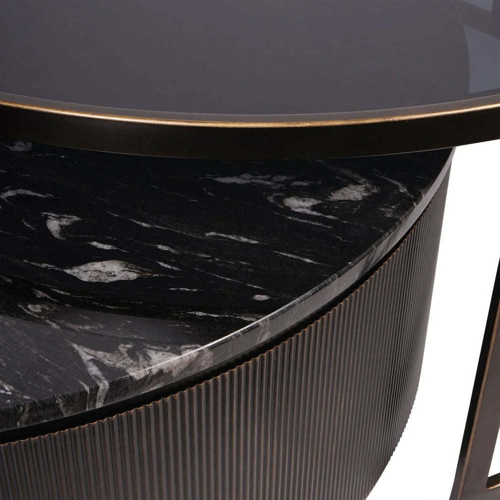 Black nesting coffee tables with marble texture and ribbed edge detail.