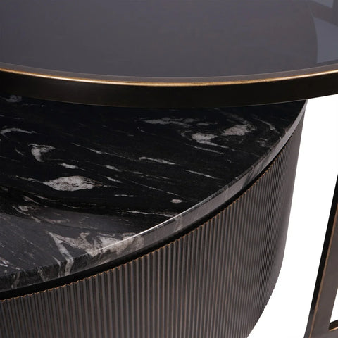 Black nesting coffee tables with marble texture and ribbed edge detail.