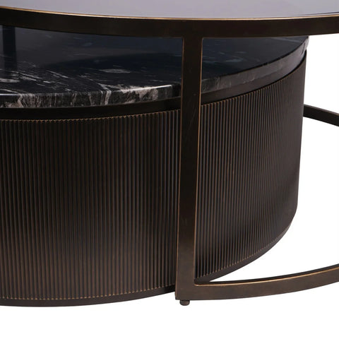 Black nesting table with ribbed texture and marble top detail.