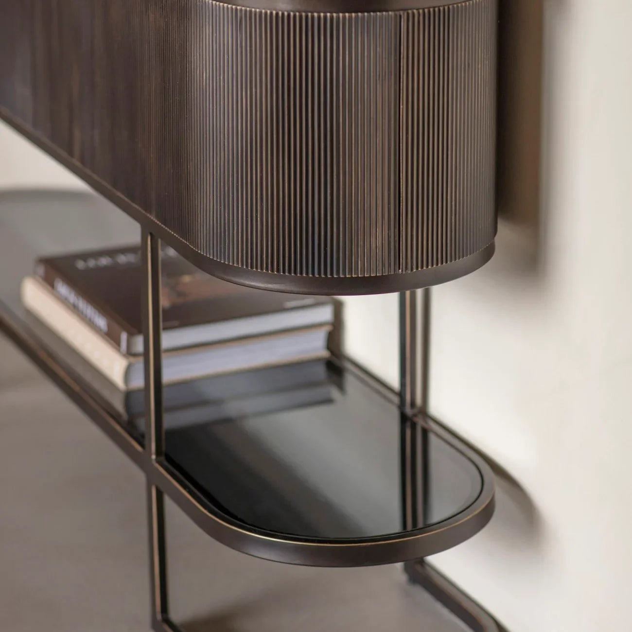 Black console table with ribbed wood detail and marble top.