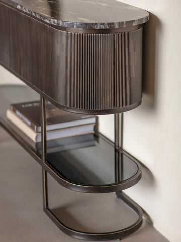 Black console table with ribbed wood detail and marble top.