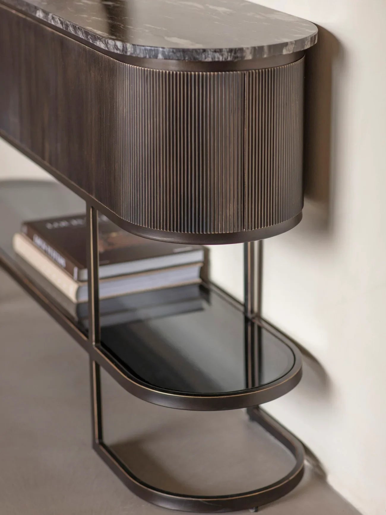 Black console table with ribbed wood detail and marble top.