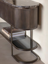 Black console table with ribbed wood detail and marble top.