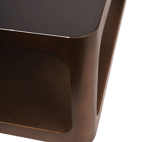 Bronze metal coffee table corner with dark glass top.