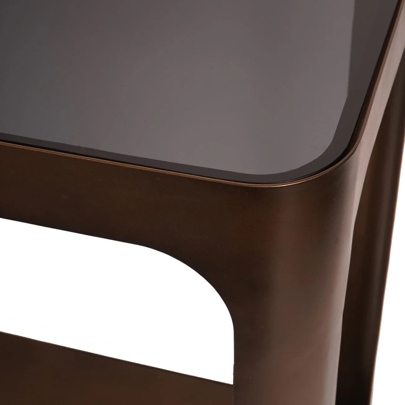 Bronze metal console table corner with dark glass top.