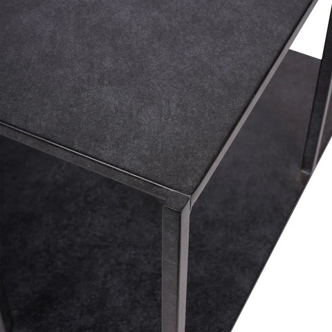 Mottled black coffee table corner with textured surface.
