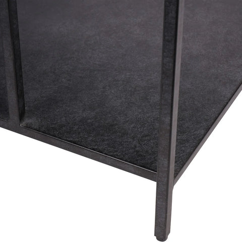 Dark mottled surface with sleek metal legs of a coffee table.