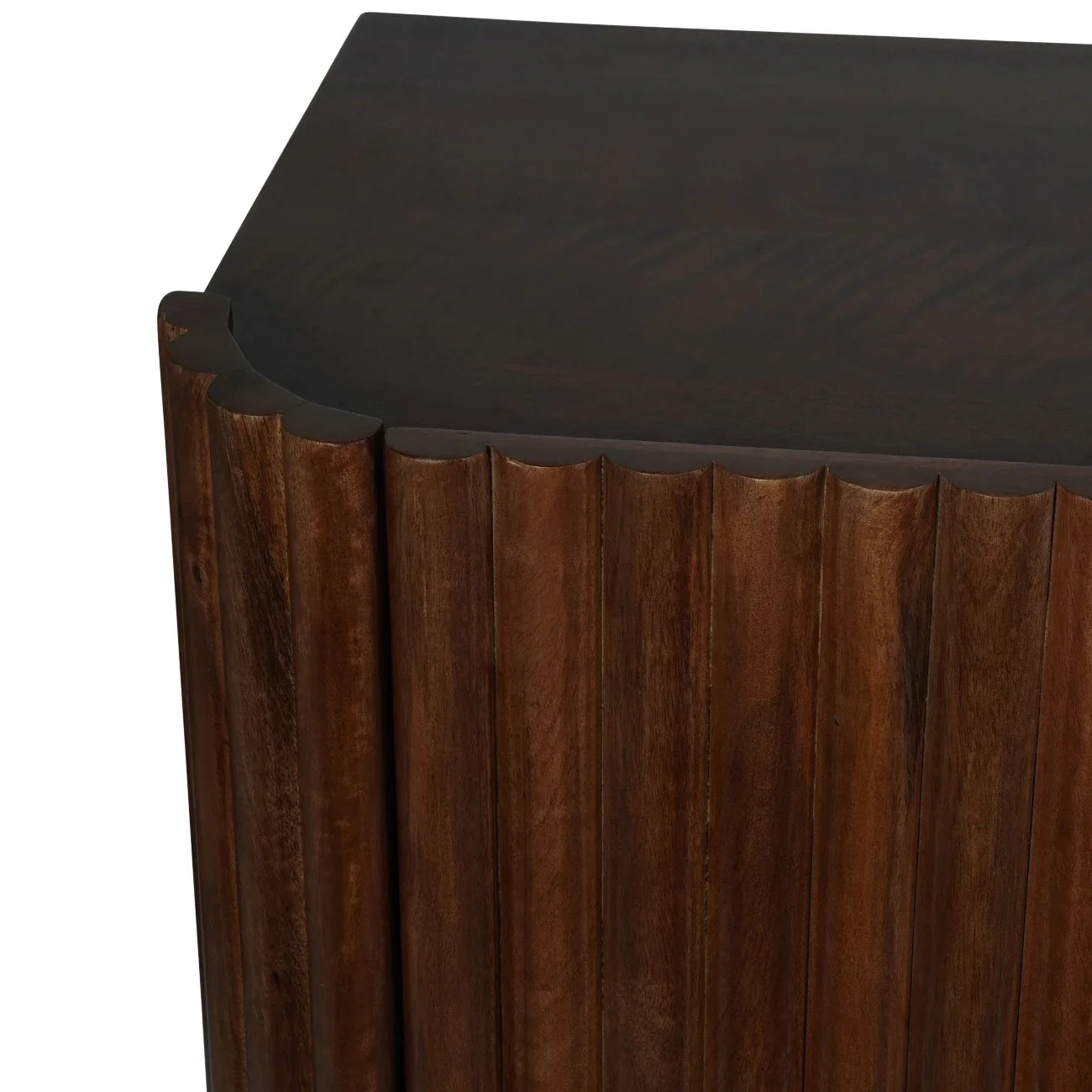 Dark wood sideboard corner with scalloped edge design