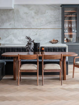 Wooden dining table with chairs in a modern dining room setting.
