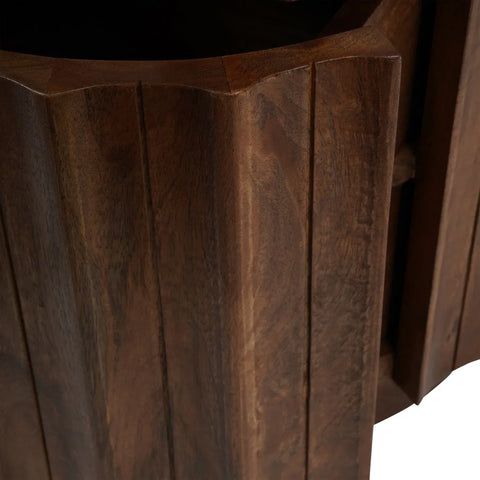 Dark wood bedside table showing curved panel detail