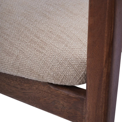 Beige upholstered seat with textured fabric and wooden frame detail.
