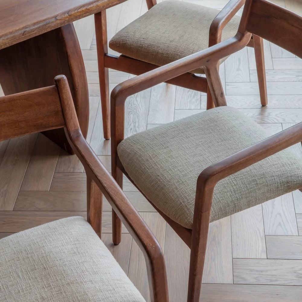 Beige upholstered chairs with wooden frames around a dining table.