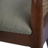 Close-up of oak armchair showing textured upholstery and cane detail.