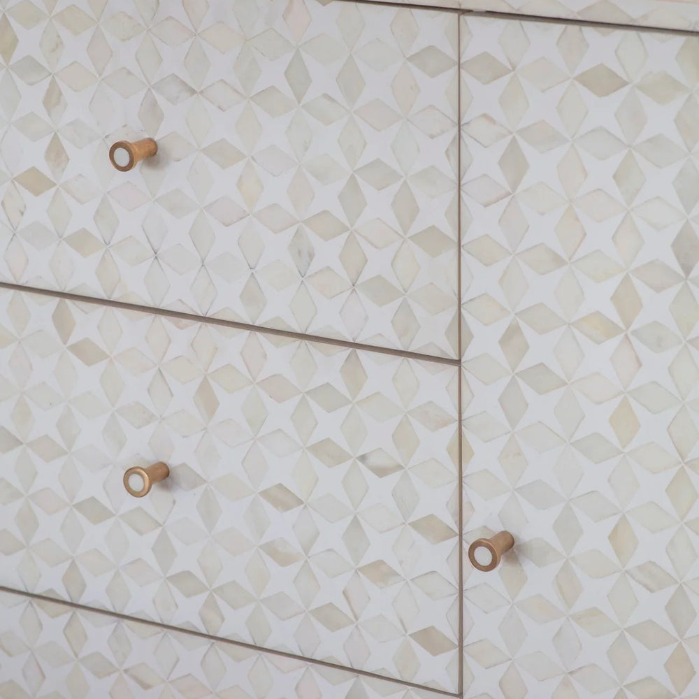 White geometric patterned sideboard with wooden knobs.
