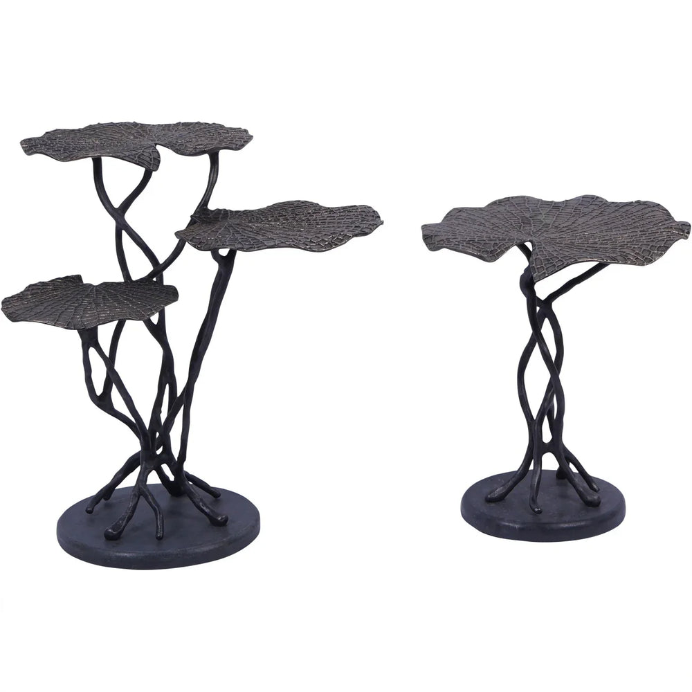 Two dark cast aluminium tables with leaf-shaped tops and twisted stems.