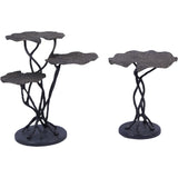 Two dark cast aluminium tables with leaf-shaped tops and twisted stems.