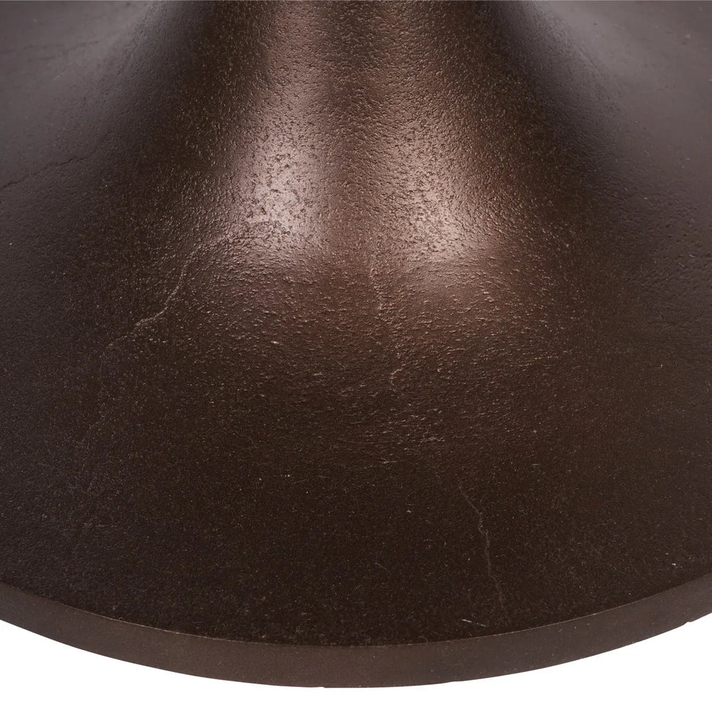 Dark brown textured base of a side table with a smooth finish.