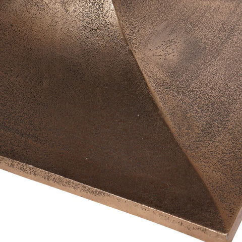 Bronze textured surface with subtle speckled pattern on table base.