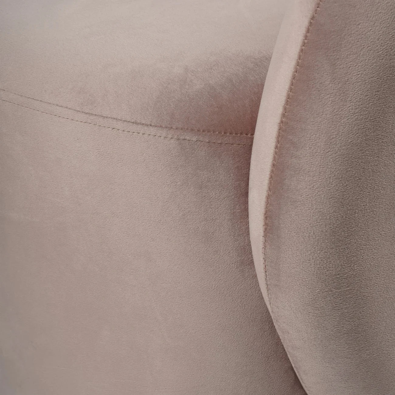 Dusky pink velvet chair showing soft texture and stitching detail.