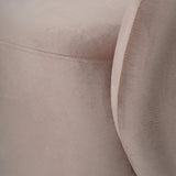 Dusky pink velvet chair showing soft texture and stitching detail.