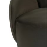 Dark green velvet chair showing smooth upholstery detail.