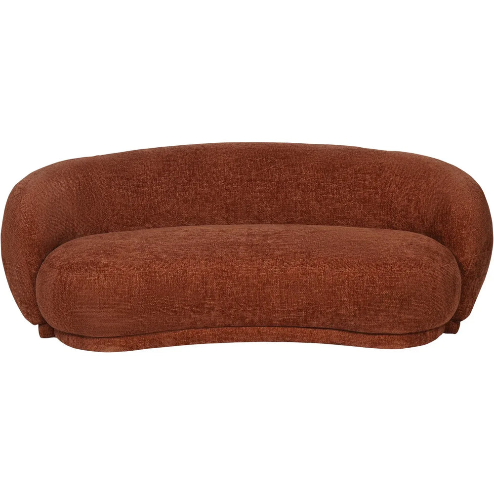 Terracotta curved sofa with textured fabric and plush cushions.