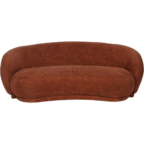 Terracotta curved sofa with textured fabric and plush cushions.