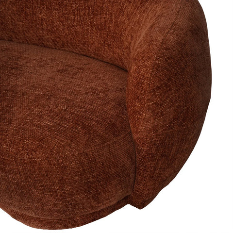 Terracotta sofa detail showing textured fabric and curved design.