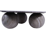 Marble coffee table with spherical stone legs and smooth top.